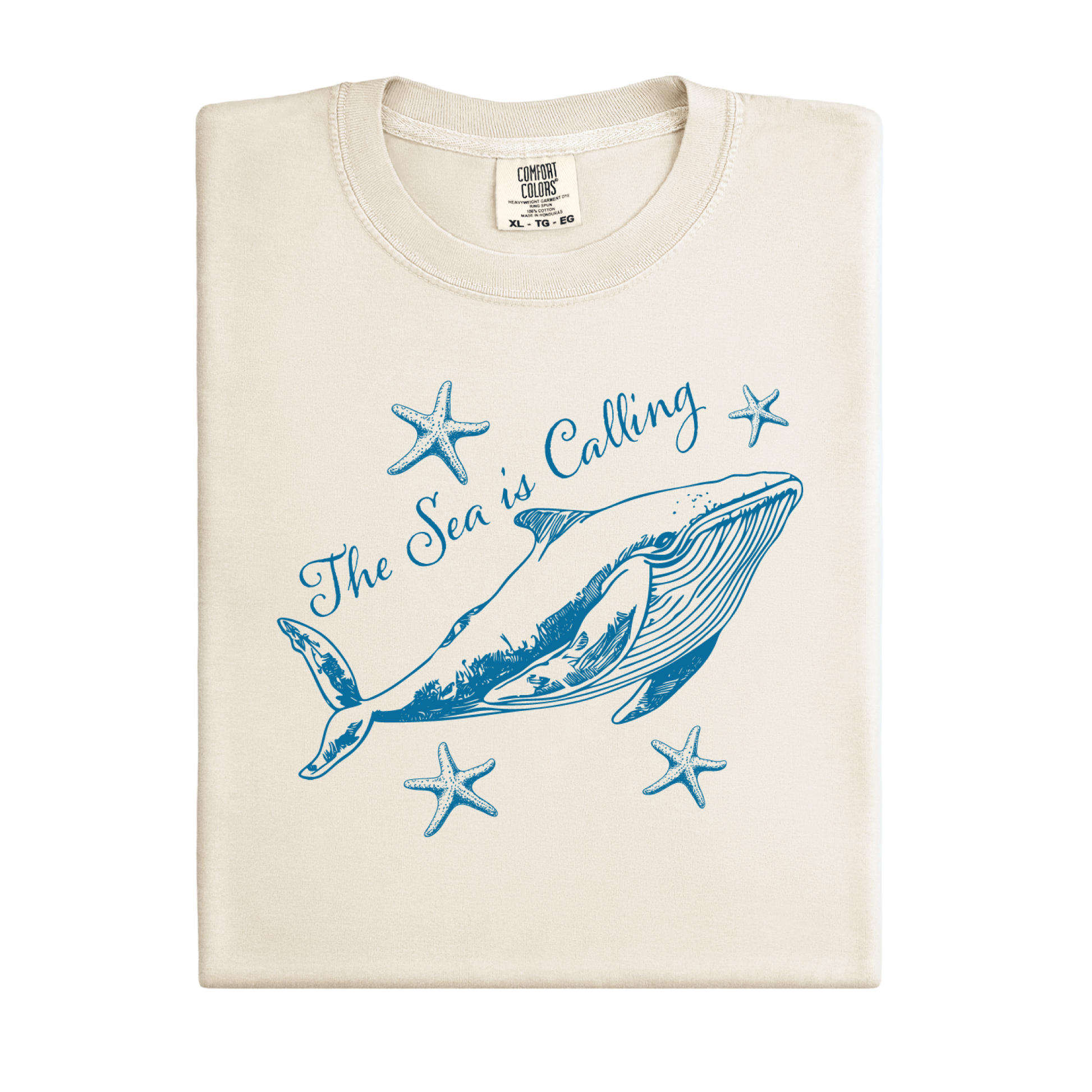 Comfort Colors t-shirt featuring a blue whale illustration surrounded by starfish and the handwritten-style text “The Sea is Calling.” The detailed marine artwork creates a calming coastal aesthetic. This unisex garment-dyed tee offers a soft vintage feel and relaxed fit, perfect for ocean lovers, beach trips, and anyone who enjoys sea-themed graphic shirts with a coastal vibe.