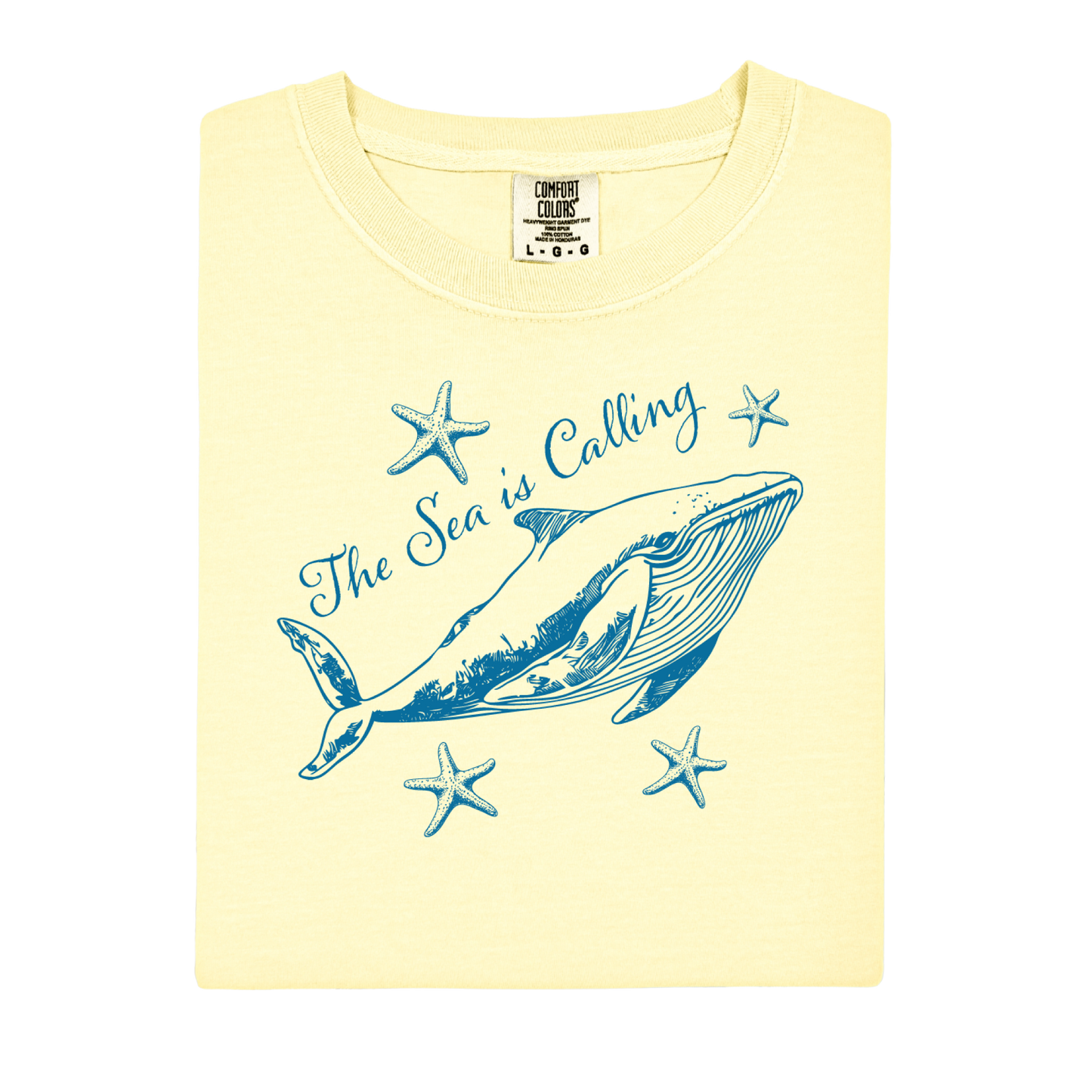 Comfort Colors t-shirt featuring a blue whale illustration surrounded by starfish and the handwritten-style text “The Sea is Calling.” The detailed marine artwork creates a calming coastal aesthetic. This unisex garment-dyed tee offers a soft vintage feel and relaxed fit, perfect for ocean lovers, beach trips, and anyone who enjoys sea-themed graphic shirts with a coastal vibe.