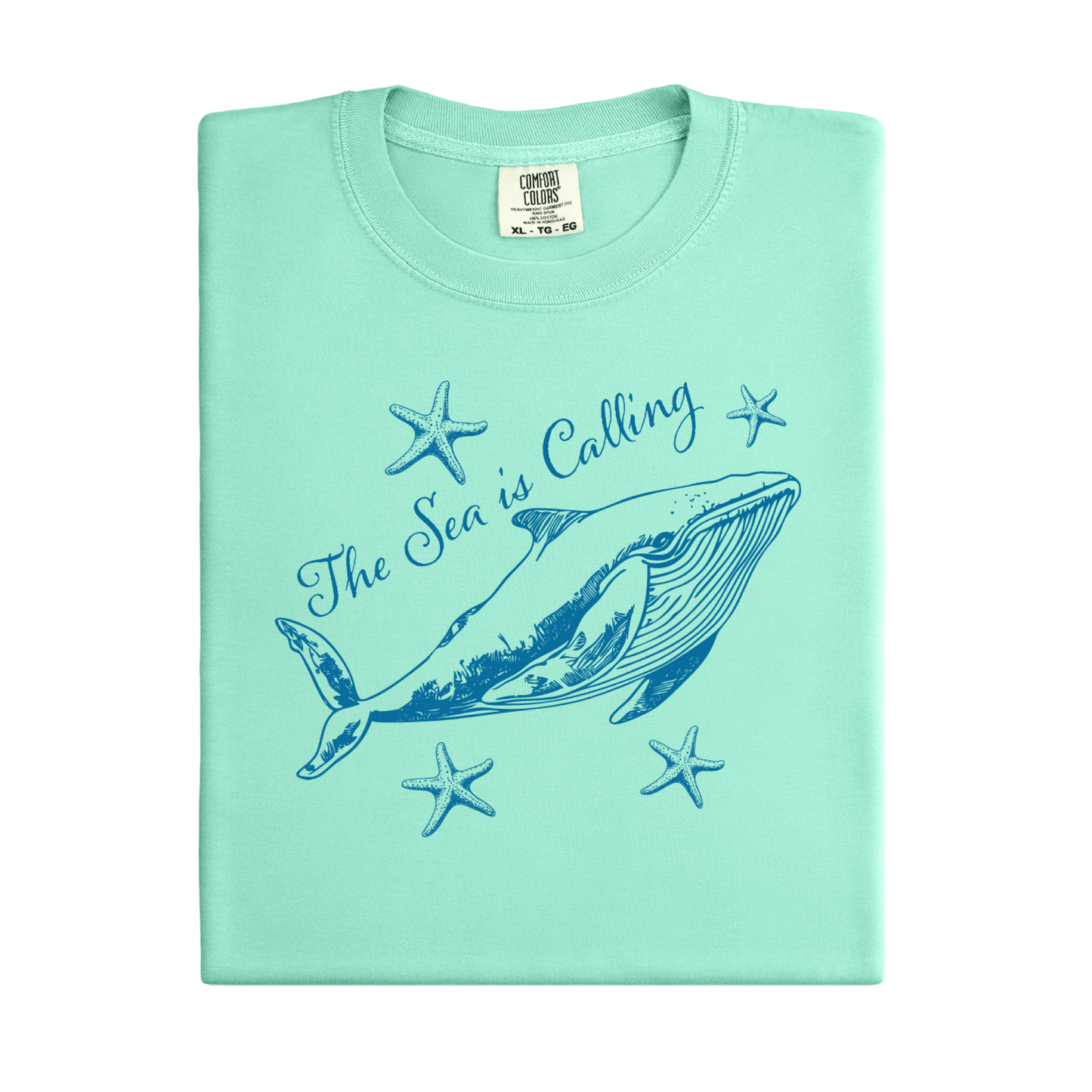 Comfort Colors t-shirt featuring a blue whale illustration surrounded by starfish and the handwritten-style text “The Sea is Calling.” The detailed marine artwork creates a calming coastal aesthetic. This unisex garment-dyed tee offers a soft vintage feel and relaxed fit, perfect for ocean lovers, beach trips, and anyone who enjoys sea-themed graphic shirts with a coastal vibe.