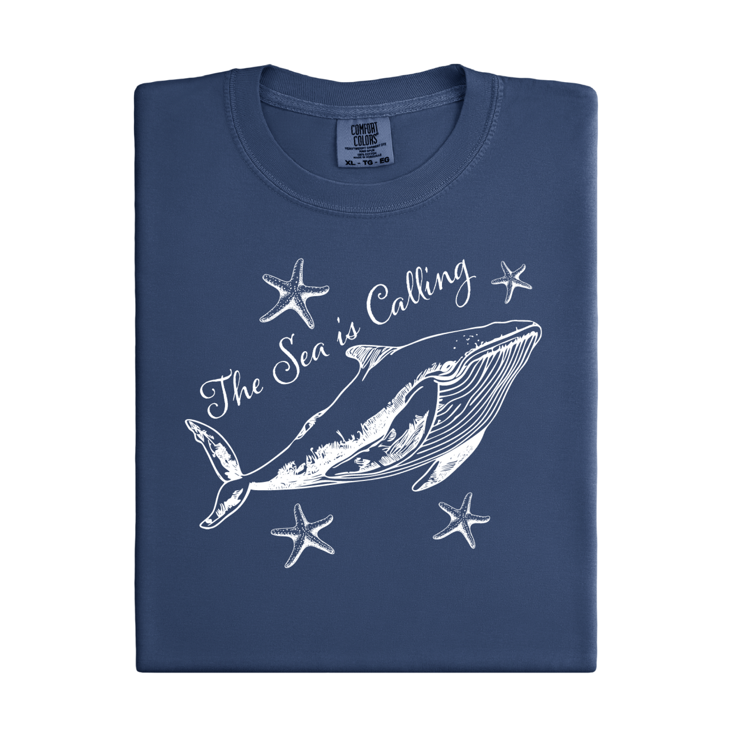 Comfort Colors t-shirt featuring a blue whale illustration surrounded by starfish and the handwritten-style text “The Sea is Calling.” The detailed marine artwork creates a calming coastal aesthetic. This unisex garment-dyed tee offers a soft vintage feel and relaxed fit, perfect for ocean lovers, beach trips, and anyone who enjoys sea-themed graphic shirts with a coastal vibe.