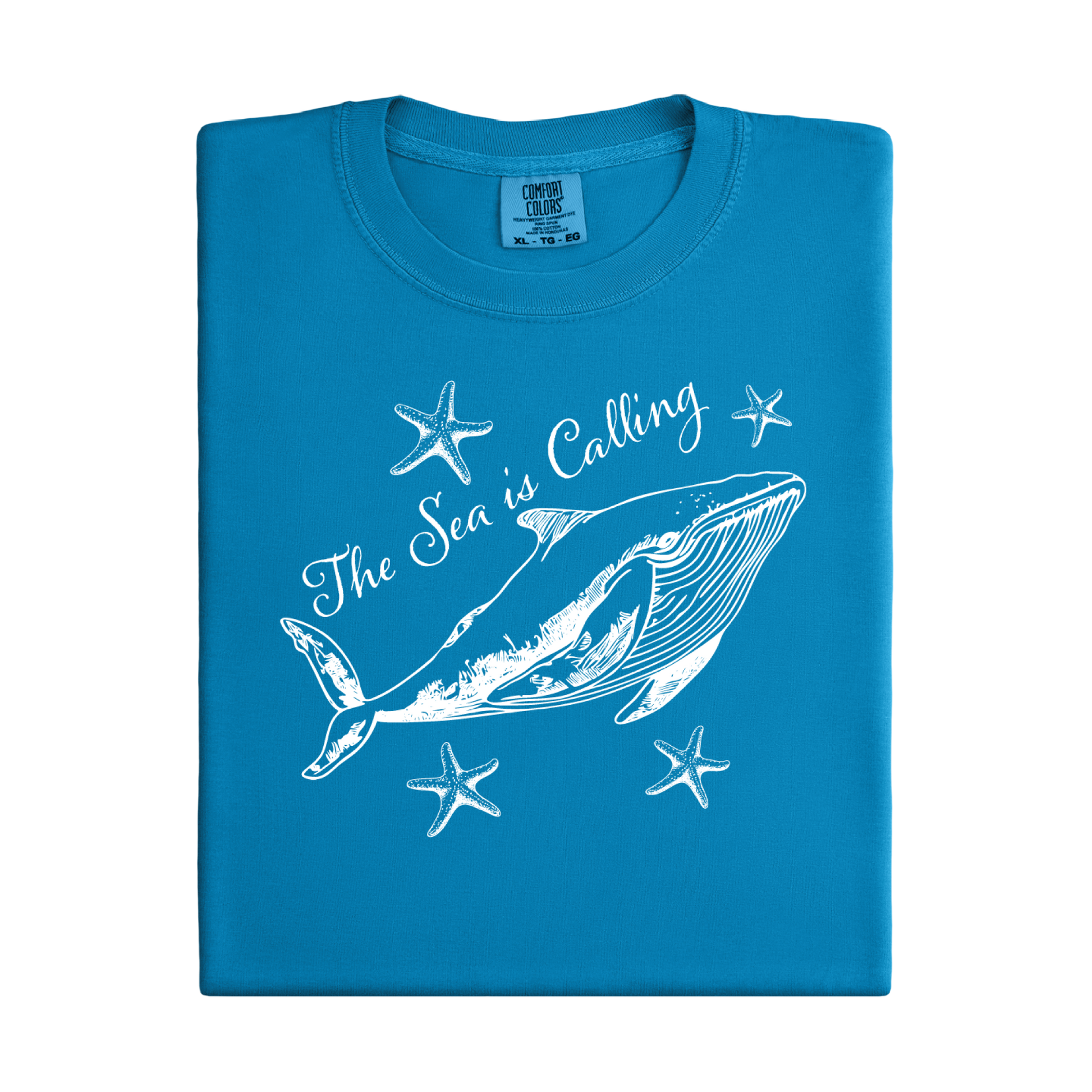 Comfort Colors t-shirt featuring a blue whale illustration surrounded by starfish and the handwritten-style text “The Sea is Calling.” The detailed marine artwork creates a calming coastal aesthetic. This unisex garment-dyed tee offers a soft vintage feel and relaxed fit, perfect for ocean lovers, beach trips, and anyone who enjoys sea-themed graphic shirts with a coastal vibe.