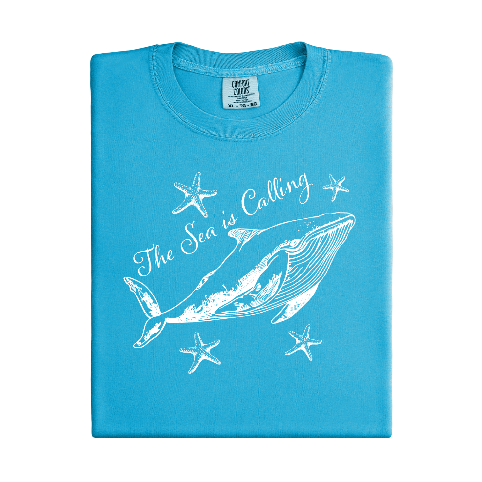 Comfort Colors t-shirt featuring a blue whale illustration surrounded by starfish and the handwritten-style text “The Sea is Calling.” The detailed marine artwork creates a calming coastal aesthetic. This unisex garment-dyed tee offers a soft vintage feel and relaxed fit, perfect for ocean lovers, beach trips, and anyone who enjoys sea-themed graphic shirts with a coastal vibe.