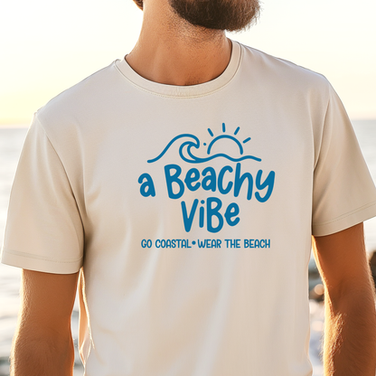 Person wearing a t-shirt with 'a Beachy Vibe' text and design, standing by the beach.