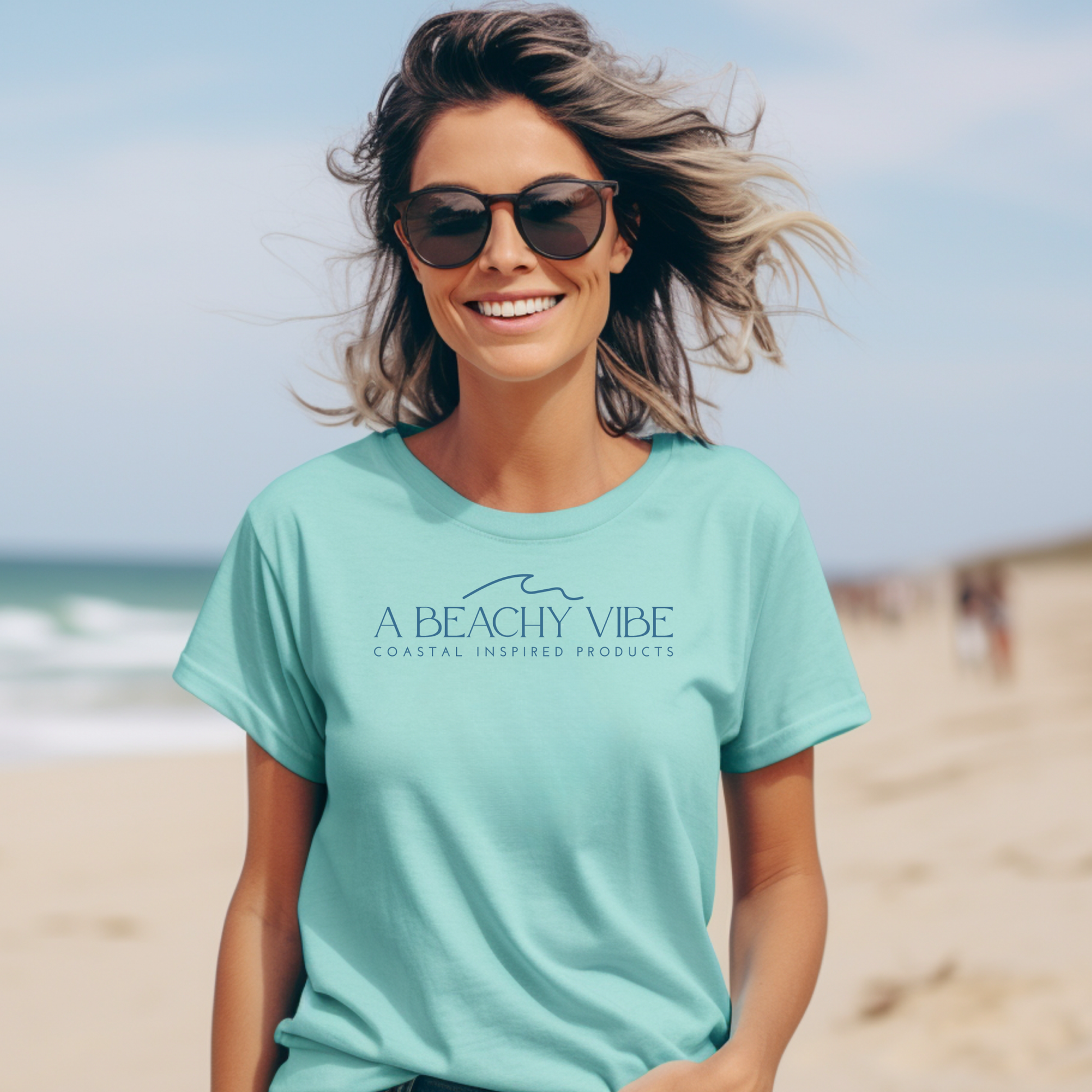 Comfort Colors 1717 "A Beachy Vibe" t shirt with a simple wave one color graphic. Picture of a girl standing on the beach in a t shirt.