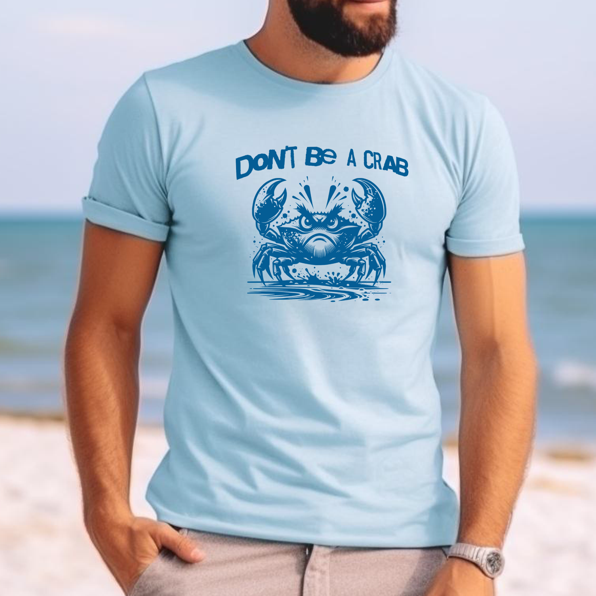 Comfort Colors 1717 "Don't Be A Crab" t shirt with cute crab looking angry with  in a  one color graphic. Picture of a man standing on the beach wearing a t shirt.
