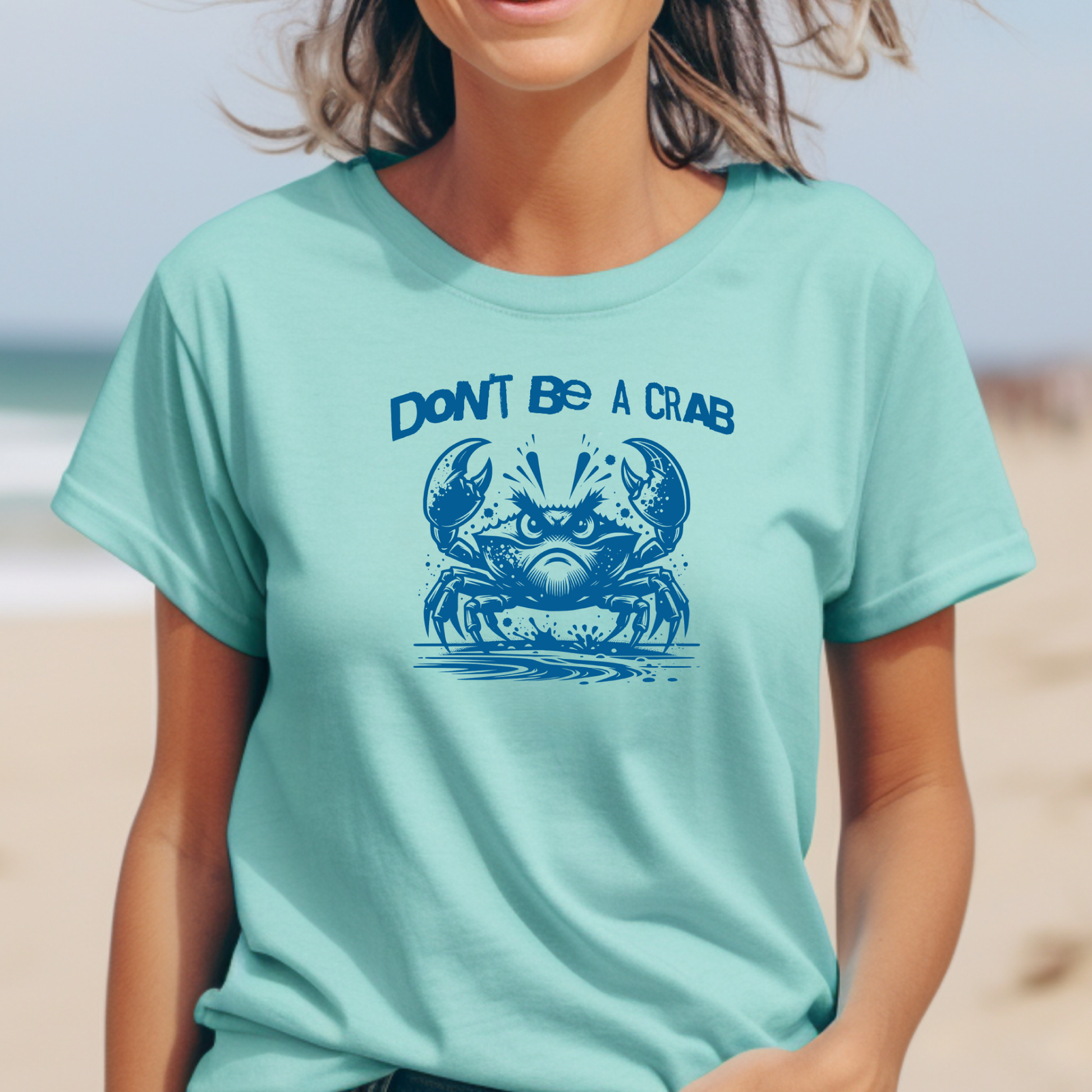 Comfort Colors 1717 "Don't Be A Crab" t shirt with cute crab looking angry with  in a  one color graphic. Picture of a girl standing on the beach wearing a t shirt.