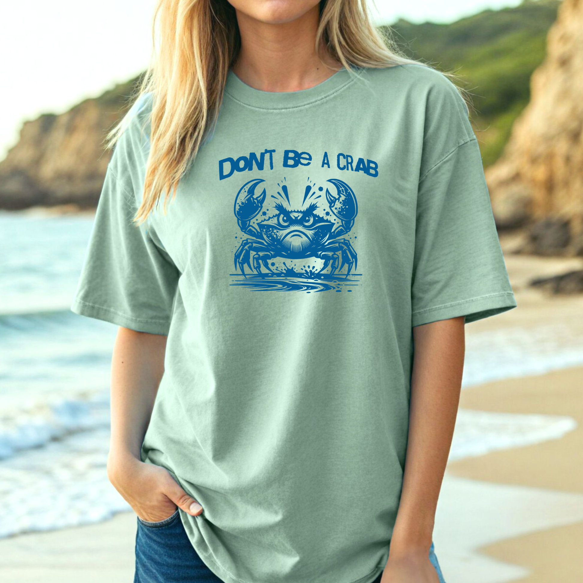 Comfort Colors 1717 "Don't Be A Crab" t shirt with cute crab looking angry with  in a  one color graphic. Picture of a girl standing on the beach wearing an oversized t shirt.