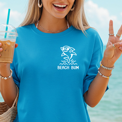 Woman wearing a blue 'Beach Bum' shirt by the ocean