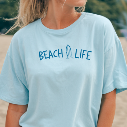 Person wearing a light blue 'Beach Life' t-shirt outdoors.