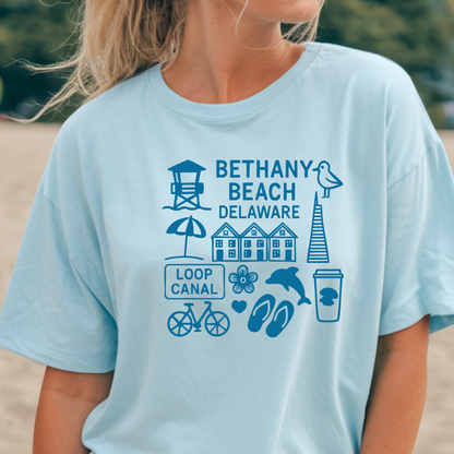 Light blue t-shirt with Bethany Beach, Delaware graphics worn by a person on a beach.