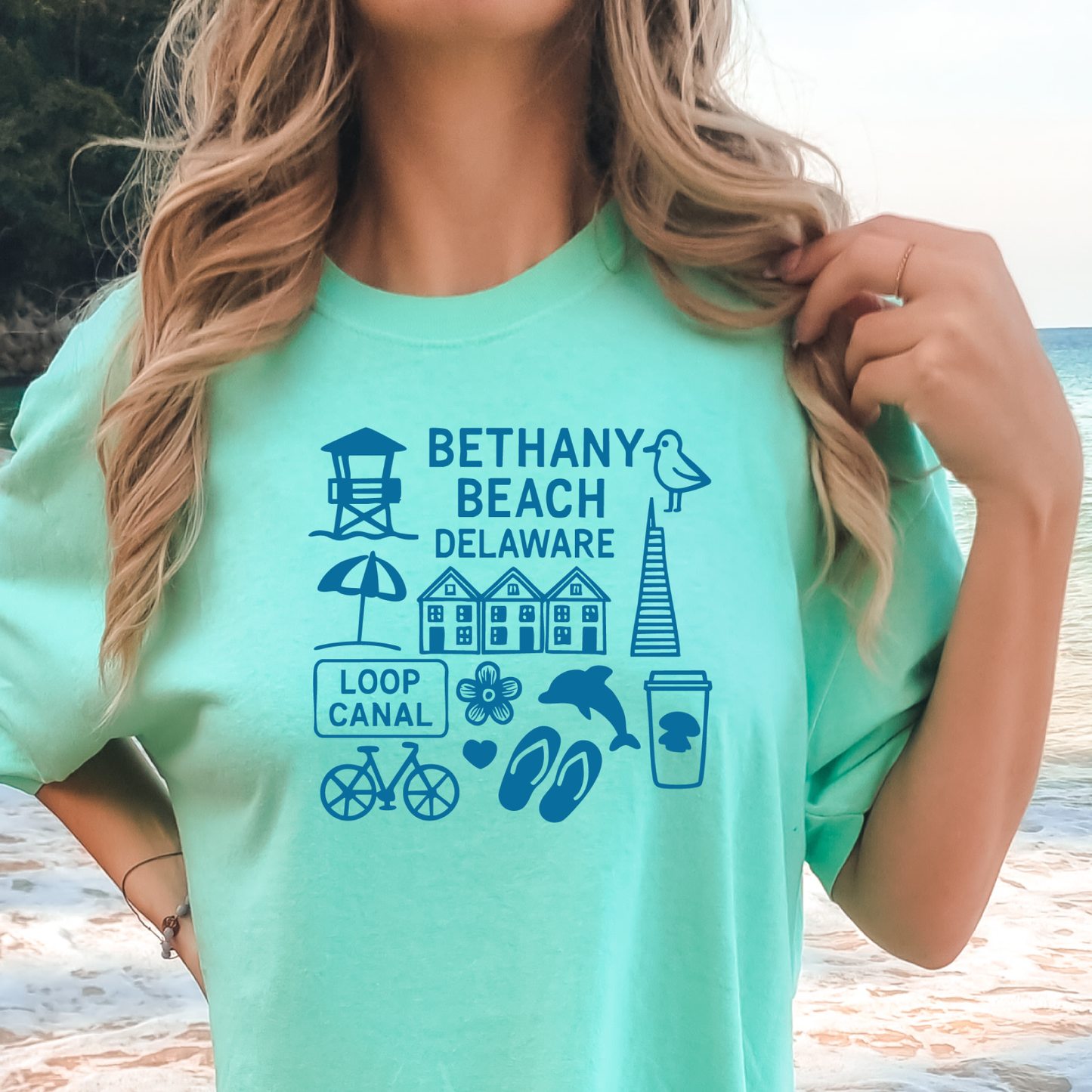 Person wearing a green t-shirt with Bethany Beach, Delaware graphics.