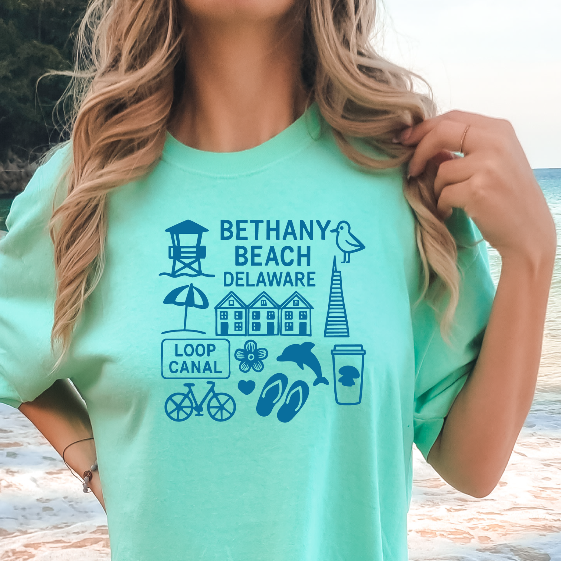 Person wearing a green t-shirt with Bethany Beach, Delaware graphics.