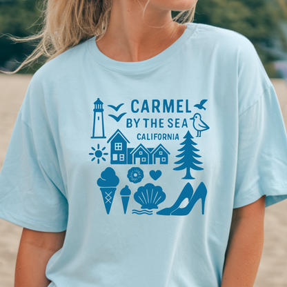 Light blue t-shirt with 'Carmel by the Sea, California' design on a beach.