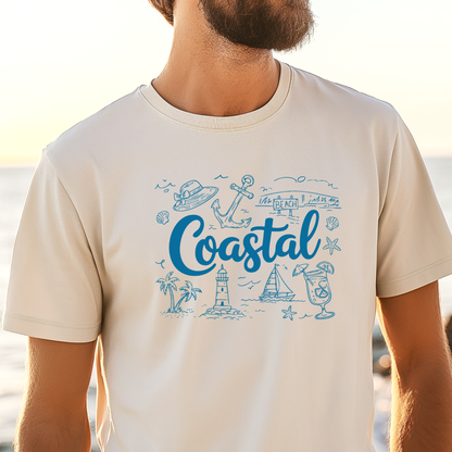 Ivory t-shirt with blue coastal graphics and text worn by a person at the beach.