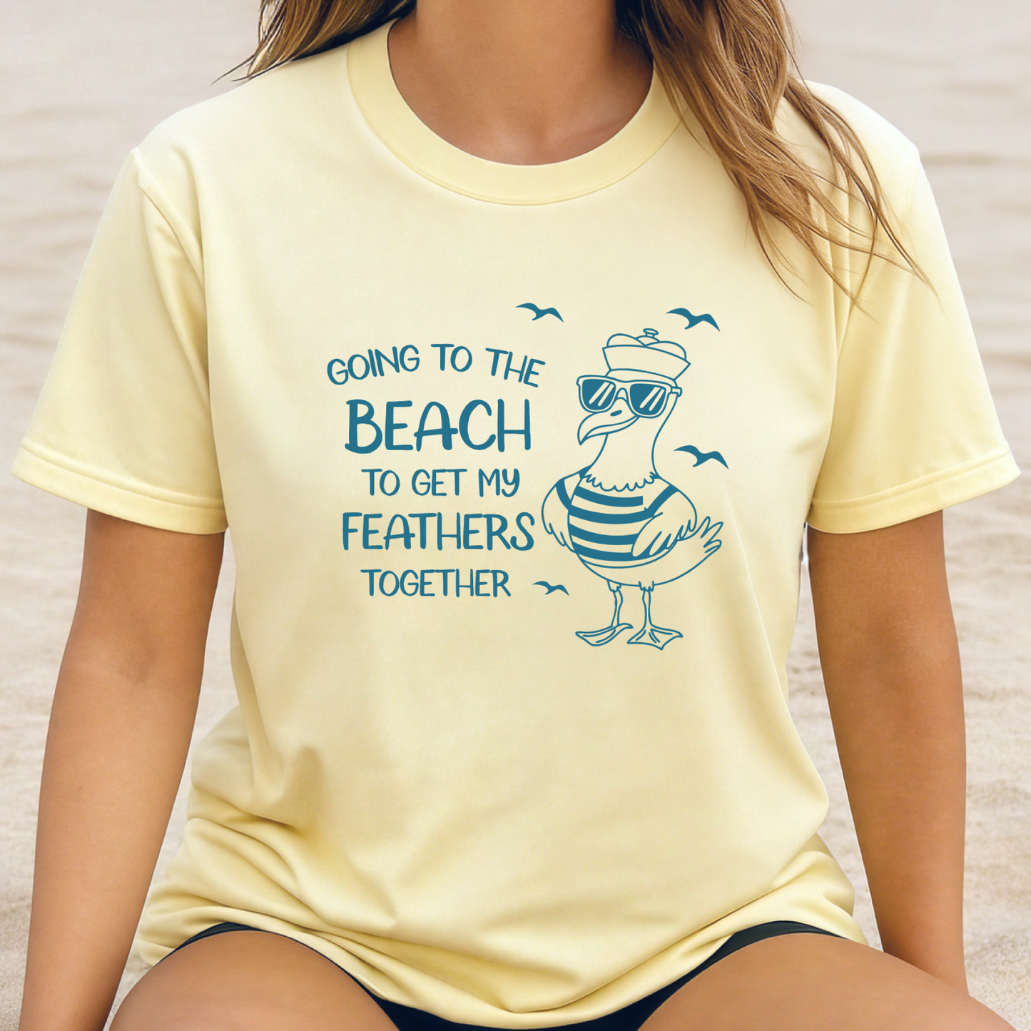 Comfort Colors t-shirt featuring a humorous blue seagull graphic wearing sunglasses and a striped shirt, beside the text “Going to the Beach to Get My Feathers Together.” Several flying birds surround the design, adding a fun coastal feel. This unisex garment-dyed tee offers a soft, vintage texture and relaxed fit, perfect for beach lovers, ocean fans, and anyone who enjoys playful summer graphic shirts.