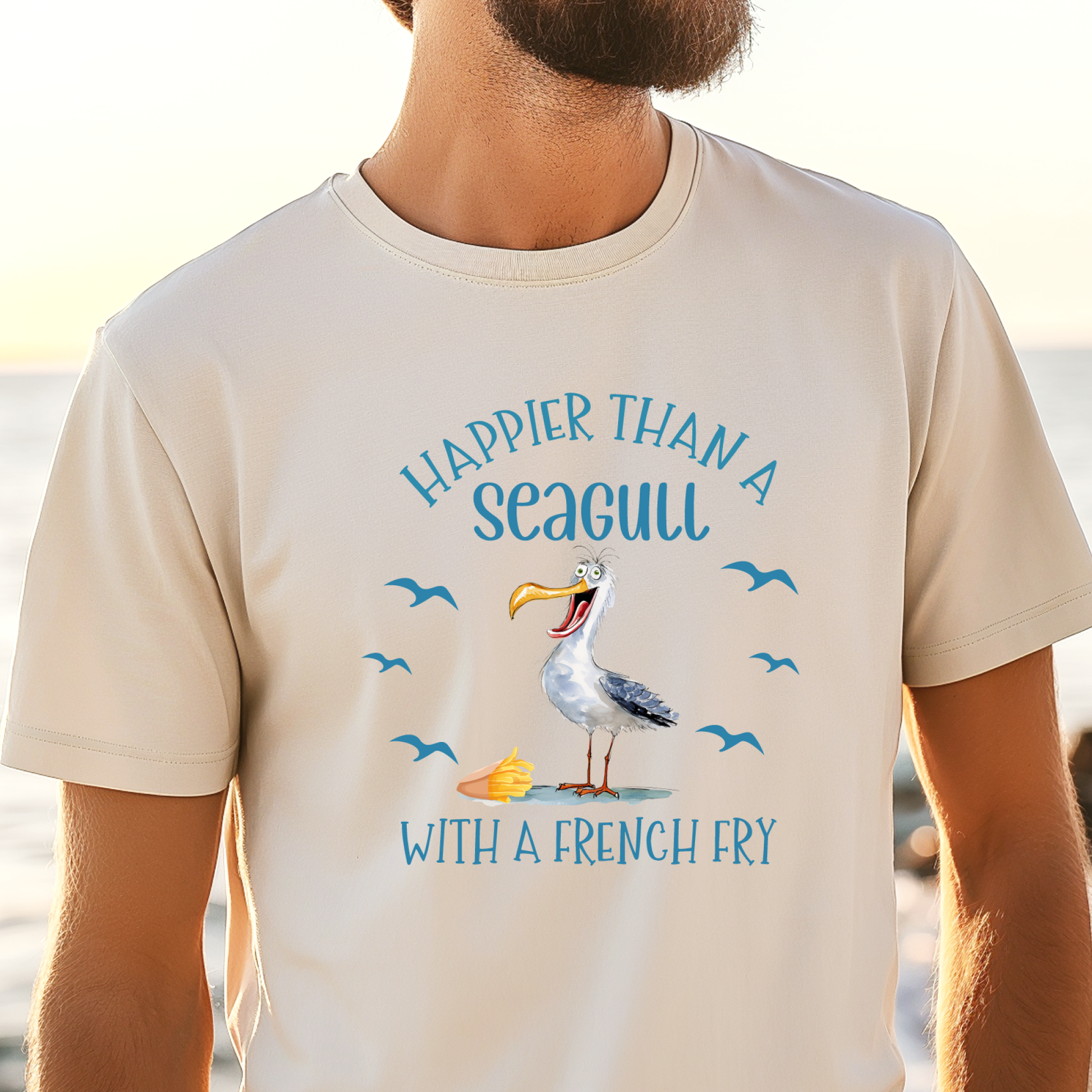 Person wearing a t-shirt with a seagull graphic and text at a beach.