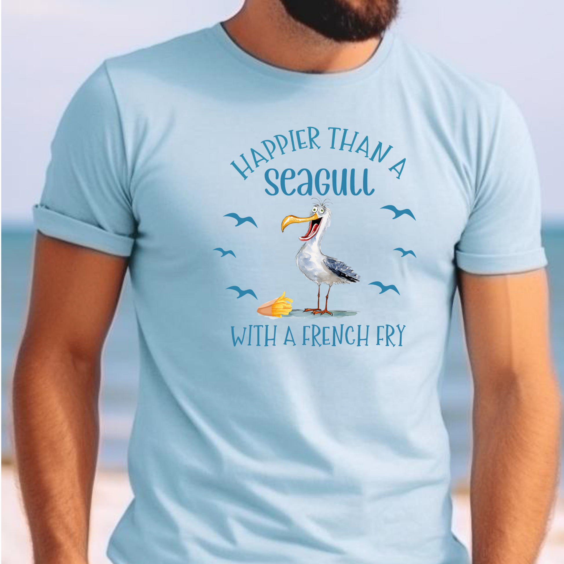 Light blue t-shirt with a seagull graphic and text on a beach background