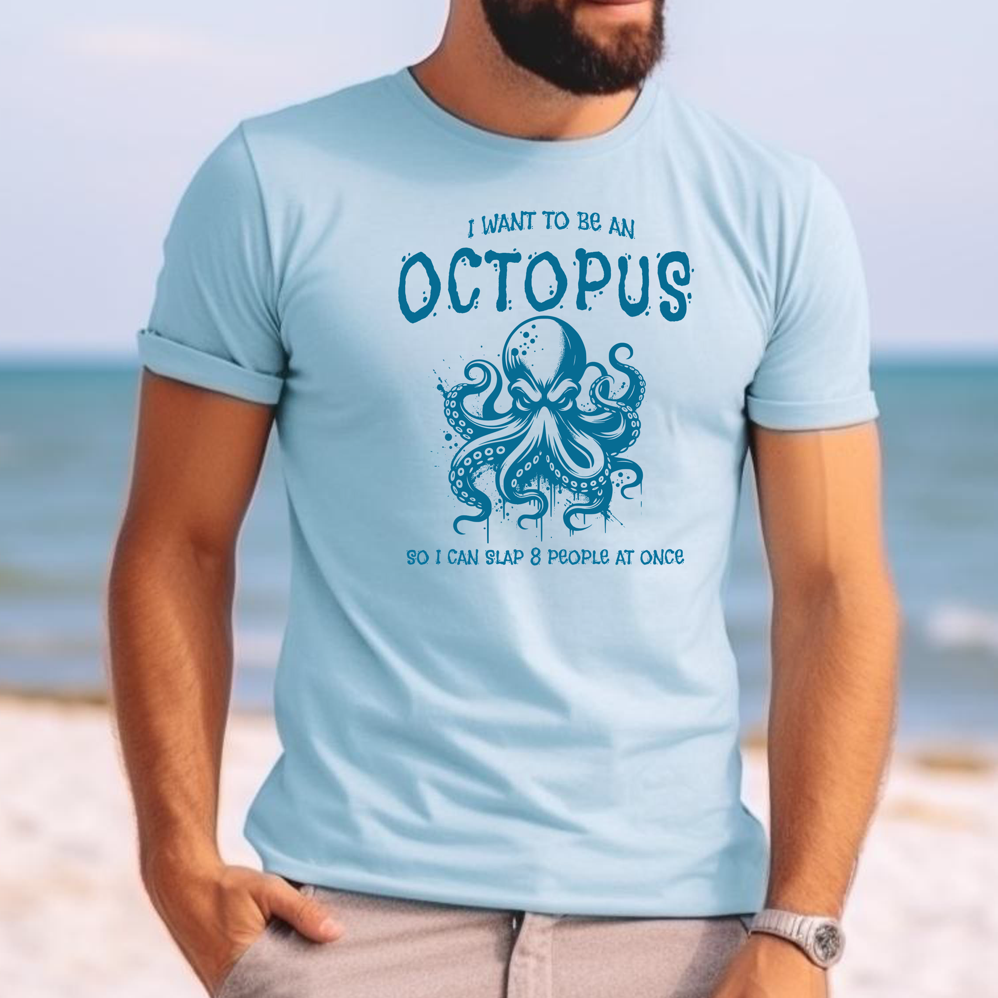 Comfort Colors 1717 "I Want To Be On Octopus So I Can Slap 8 People At Once" t shirt with an angry octopus one color graphic. Picture of a man standing on the beach in a t shirt.