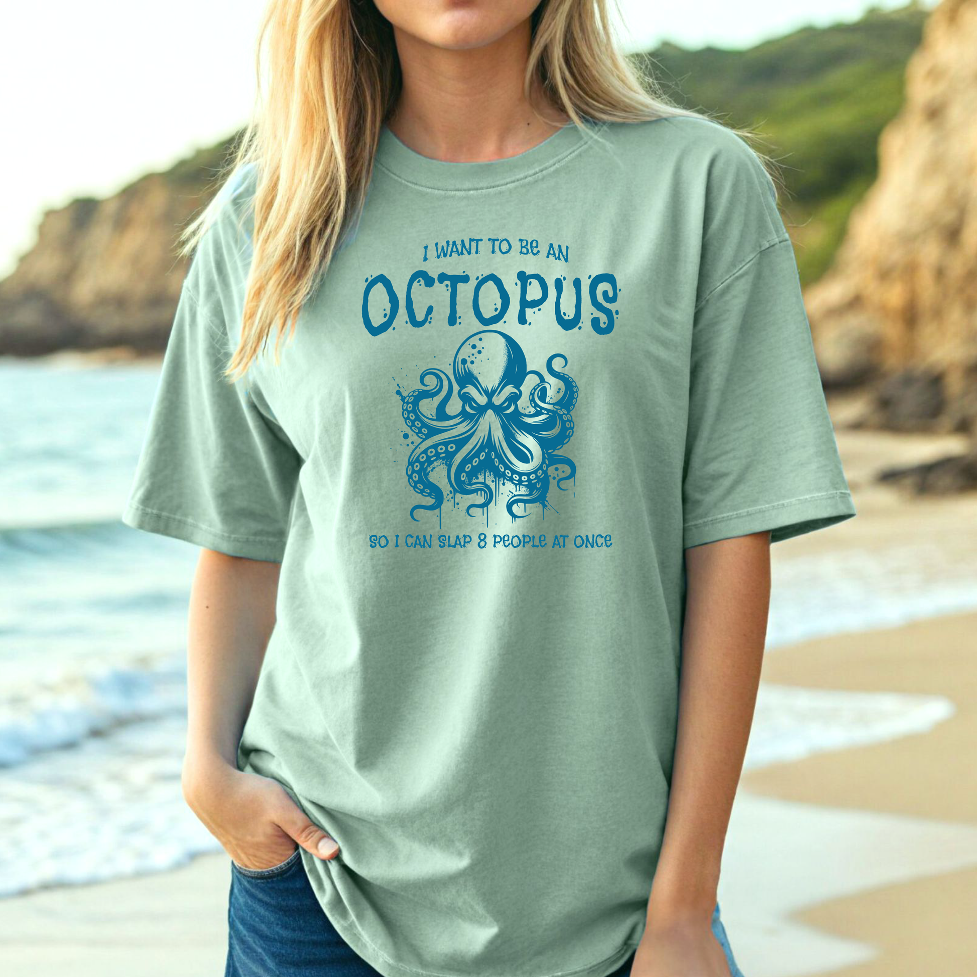 Comfort Colors 1717 "I Want To Be On Octopus So I Can Slap 8 People At Once" t shirt with an angry octopus one color graphic. Picture of a girl standing on the beach in an oversized t shirt.