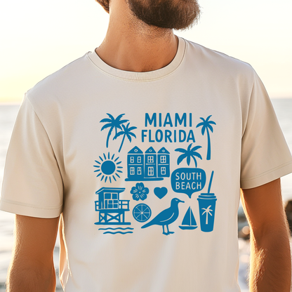 Person wearing a beige t-shirt with blue Miami, Florida-themed graphics on a beach.