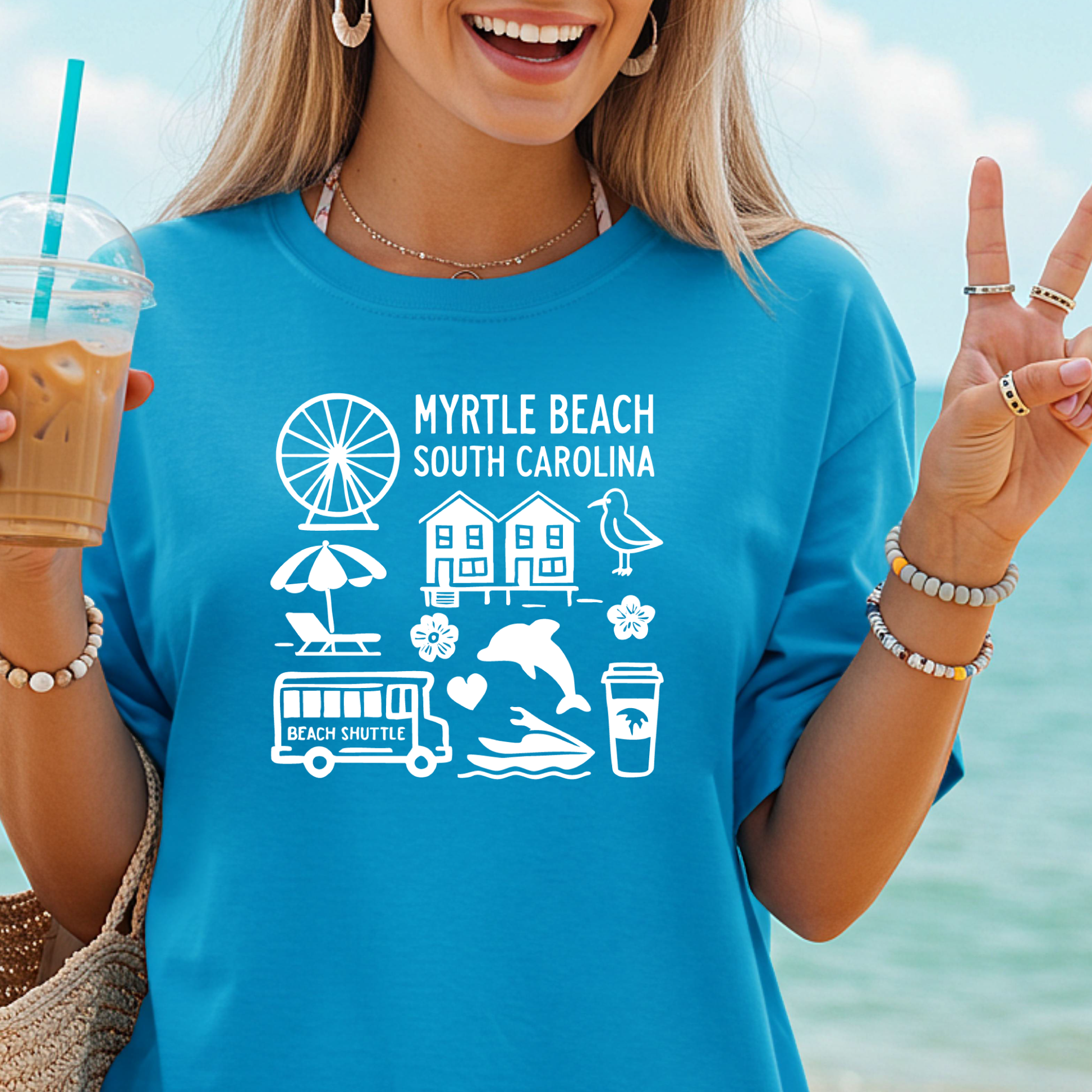Woman wearing a blue t-shirt with Myrtle Beach, South Carolina, graphics by the beach.