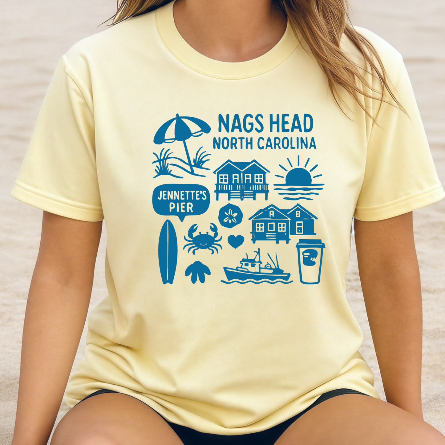 Person wearing a yellow t-shirt with blue Nags Head, North Carolina graphics.
