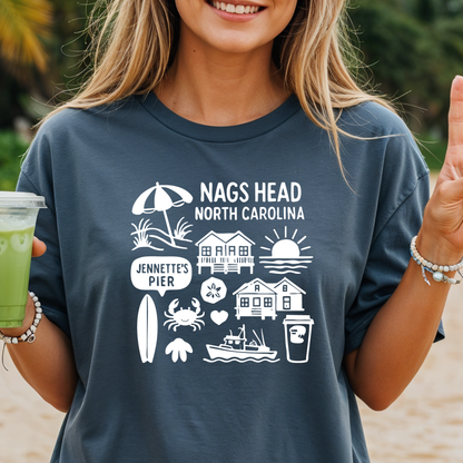 Person wearing a blue t-shirt with Nags Head, North Carolina graphics on a beach.