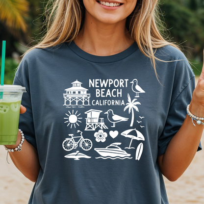 Person wearing a navy t-shirt with 'Newport Beach California' design, holding a green drink.