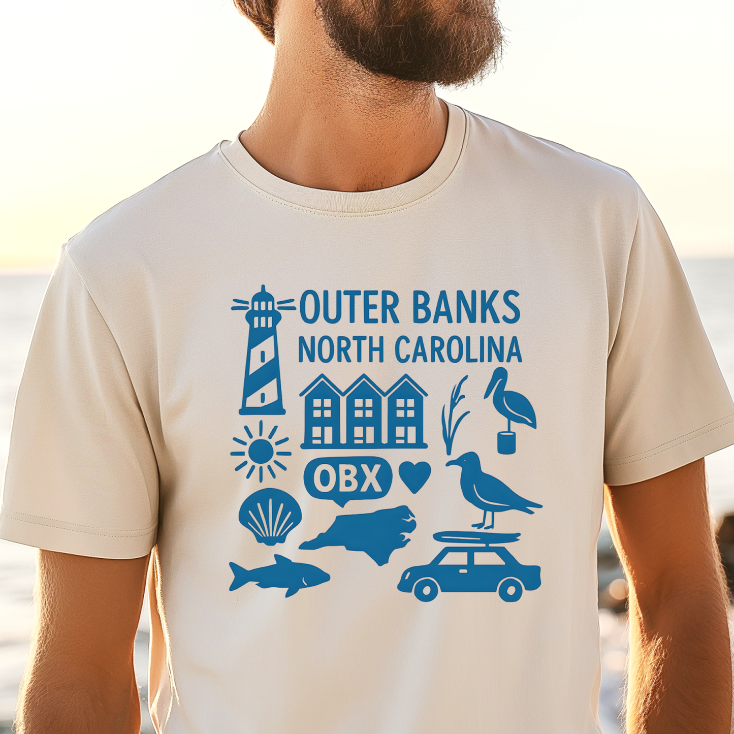 Person wearing a t-shirt with Outer Banks, North Carolina graphics on a beach.