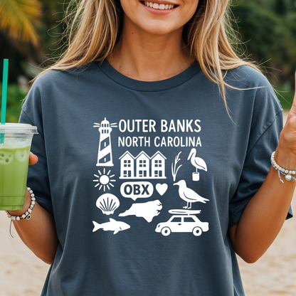 Person wearing a navy t-shirt with Outer Banks, North Carolina graphics on a beach.
