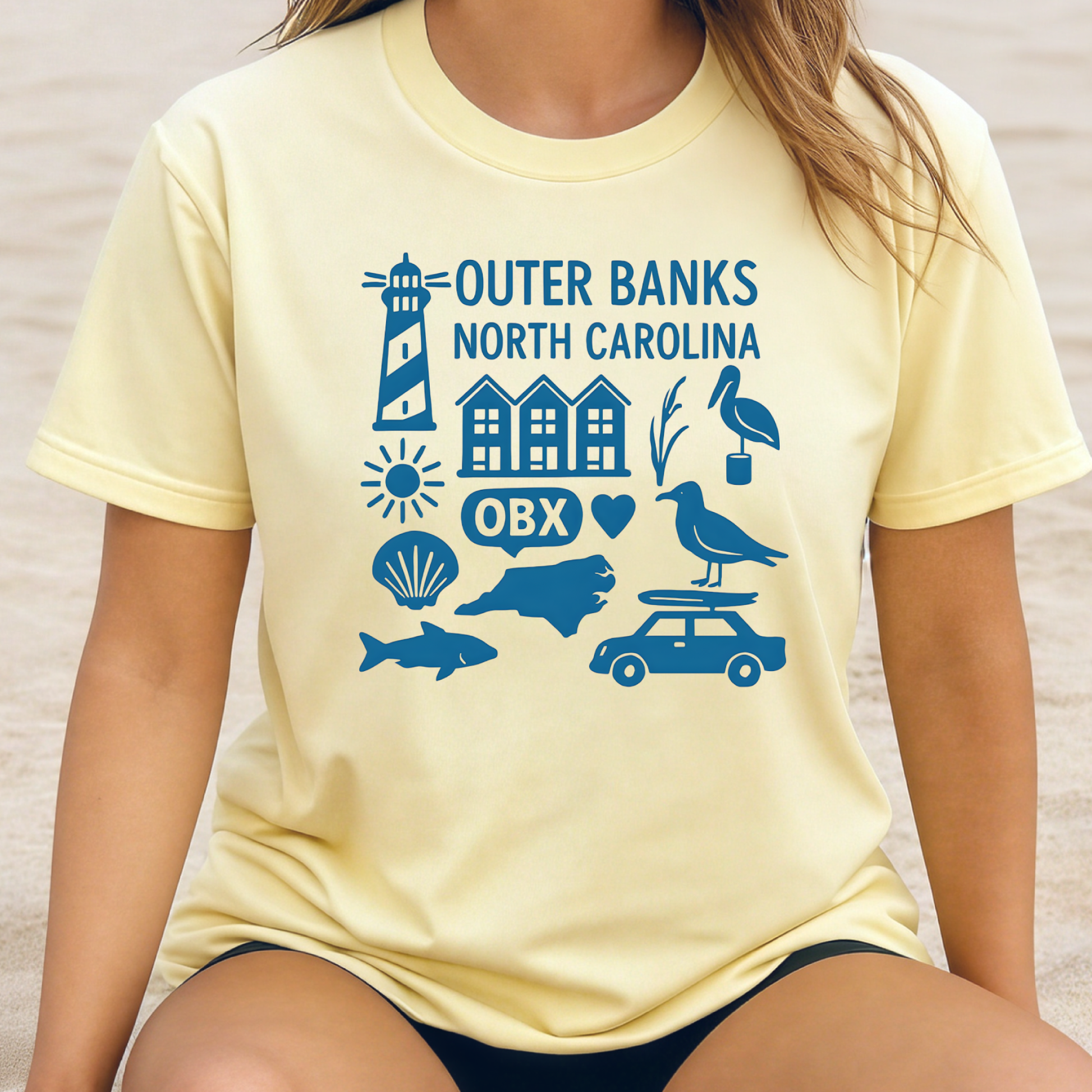Person wearing a yellow t-shirt with blue Outer Banks, North Carolina graphics.