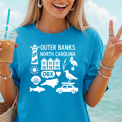 Woman wearing a blue 'Outer Banks North Carolina' t-shirt with beach-themed graphics by the ocean.