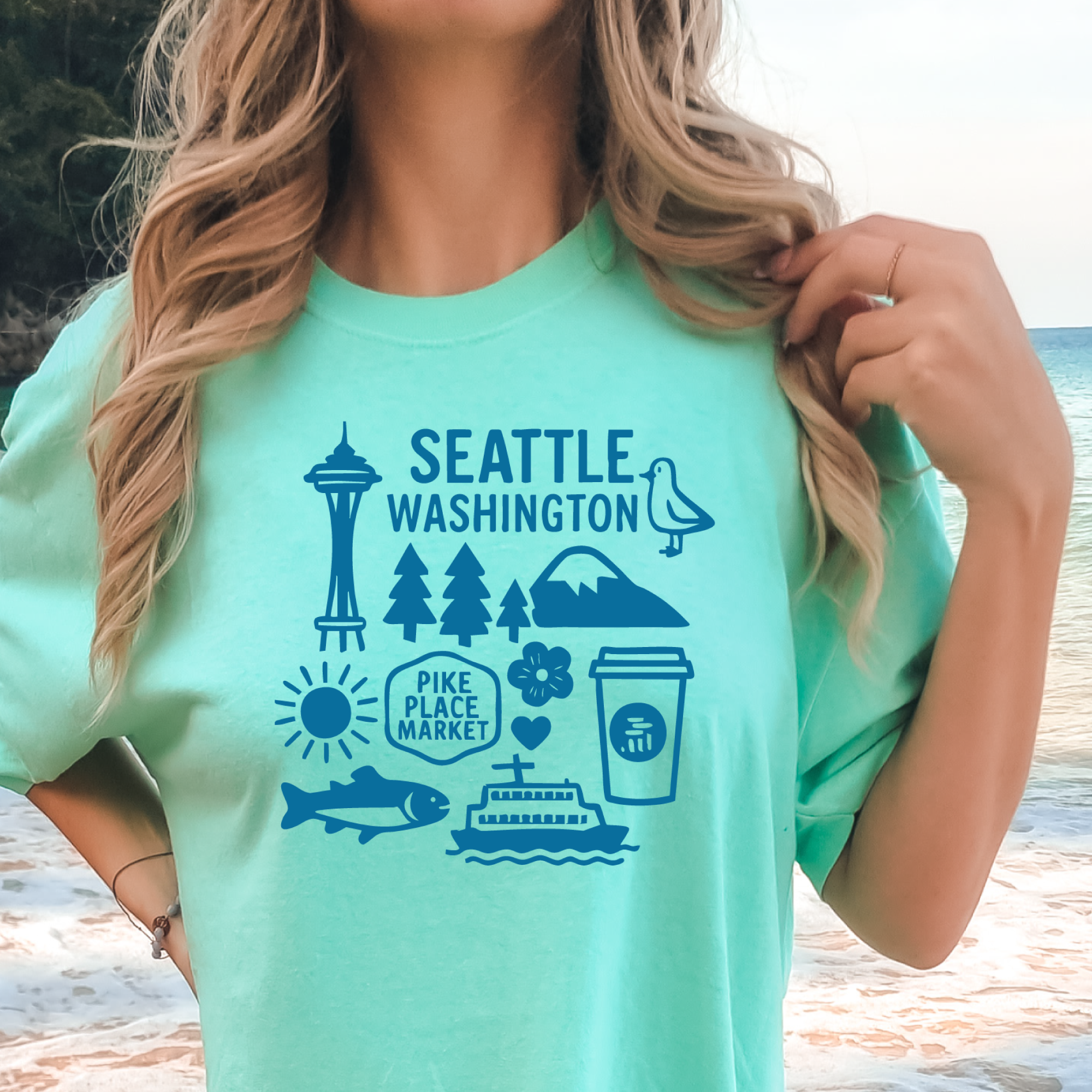 Person wearing a green t-shirt with Seattle, Washington graphics.