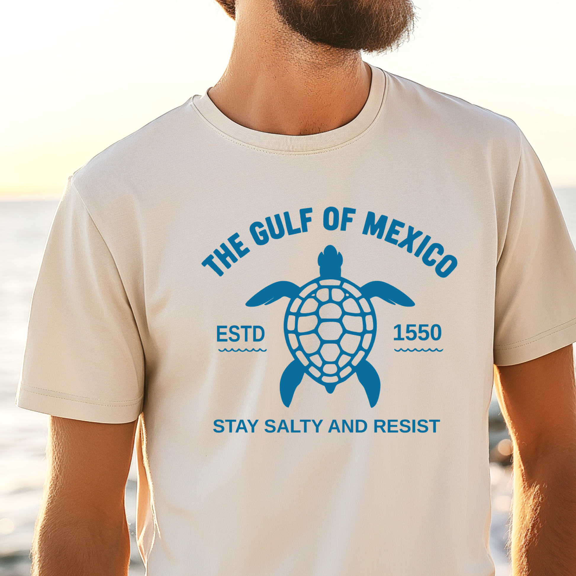 Person wearing a t-shirt with a turtle graphic and text about the Gulf of Mexico.