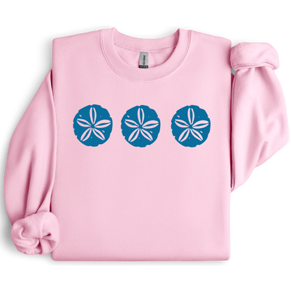 Gildan sweatshirt featuring three blue sand dollar graphics printed across the chest. Soft cotton-poly blend fabric with ribbed cuffs and waistband for a cozy, durable fit. Perfect for beach lovers and coastal style enthusiasts who appreciate simple ocean-inspired designs. Ideal for layering on cool seaside evenings or adding a subtle beach vibe to casual outfits.