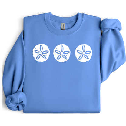 Gildan sweatshirt featuring three blue sand dollar graphics printed across the chest. Soft cotton-poly blend fabric with ribbed cuffs and waistband for a cozy, durable fit. Perfect for beach lovers and coastal style enthusiasts who appreciate simple ocean-inspired designs. Ideal for layering on cool seaside evenings or adding a subtle beach vibe to casual outfits.