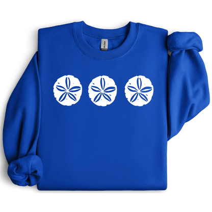 Gildan sweatshirt featuring three blue sand dollar graphics printed across the chest. Soft cotton-poly blend fabric with ribbed cuffs and waistband for a cozy, durable fit. Perfect for beach lovers and coastal style enthusiasts who appreciate simple ocean-inspired designs. Ideal for layering on cool seaside evenings or adding a subtle beach vibe to casual outfits.
