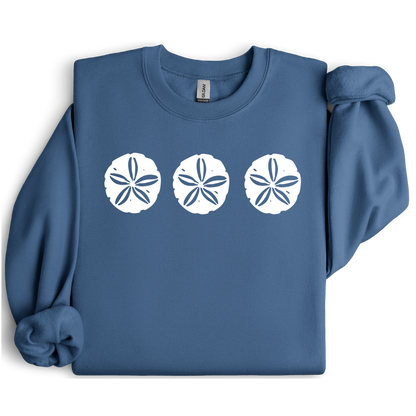 Gildan sweatshirt featuring three blue sand dollar graphics printed across the chest. Soft cotton-poly blend fabric with ribbed cuffs and waistband for a cozy, durable fit. Perfect for beach lovers and coastal style enthusiasts who appreciate simple ocean-inspired designs. Ideal for layering on cool seaside evenings or adding a subtle beach vibe to casual outfits.