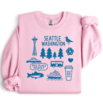 Pink sweatshirt with blue Seattle-themed graphics on a white background