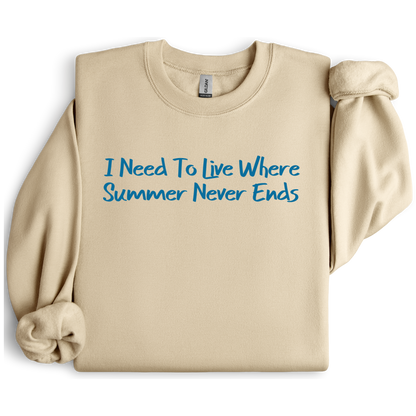Gildan sweatshirt featuring blue text that reads “I Need To Live Where Summer Never Ends.” Cozy beach-inspired pullover for those who love the sun and ocean lifestyle. Made with a soft cotton-poly blend, ribbed cuffs, and double-needle stitching for durability. Perfect for coastal adventures, vacations, or casual summer-style outfits. Ideal gift for beach lovers and anyone who wishes for endless summer days.