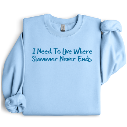 Gildan sweatshirt featuring blue text that reads “I Need To Live Where Summer Never Ends.” Cozy beach-inspired pullover for those who love the sun and ocean lifestyle. Made with a soft cotton-poly blend, ribbed cuffs, and double-needle stitching for durability. Perfect for coastal adventures, vacations, or casual summer-style outfits. Ideal gift for beach lovers and anyone who wishes for endless summer days.