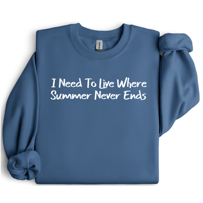 Gildan sweatshirt featuring blue text that reads “I Need To Live Where Summer Never Ends.” Cozy beach-inspired pullover for those who love the sun and ocean lifestyle. Made with a soft cotton-poly blend, ribbed cuffs, and double-needle stitching for durability. Perfect for coastal adventures, vacations, or casual summer-style outfits. Ideal gift for beach lovers and anyone who wishes for endless summer days.
