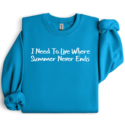 Gildan sweatshirt featuring blue text that reads “I Need To Live Where Summer Never Ends.” Cozy beach-inspired pullover for those who love the sun and ocean lifestyle. Made with a soft cotton-poly blend, ribbed cuffs, and double-needle stitching for durability. Perfect for coastal adventures, vacations, or casual summer-style outfits. Ideal gift for beach lovers and anyone who wishes for endless summer days.