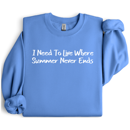 Gildan sweatshirt featuring blue text that reads “I Need To Live Where Summer Never Ends.” Cozy beach-inspired pullover for those who love the sun and ocean lifestyle. Made with a soft cotton-poly blend, ribbed cuffs, and double-needle stitching for durability. Perfect for coastal adventures, vacations, or casual summer-style outfits. Ideal gift for beach lovers and anyone who wishes for endless summer days.