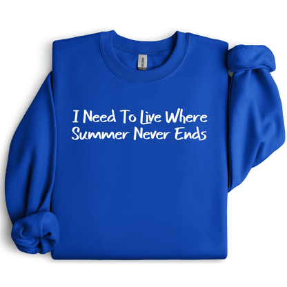 Gildan sweatshirt featuring blue text that reads “I Need To Live Where Summer Never Ends.” Cozy beach-inspired pullover for those who love the sun and ocean lifestyle. Made with a soft cotton-poly blend, ribbed cuffs, and double-needle stitching for durability. Perfect for coastal adventures, vacations, or casual summer-style outfits. Ideal gift for beach lovers and anyone who wishes for endless summer days.