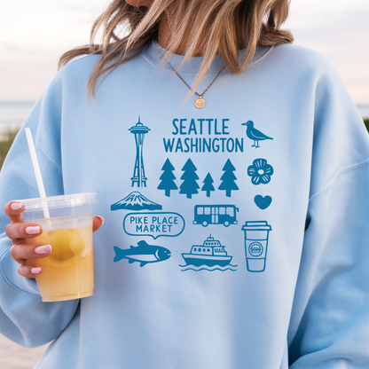 Light blue sweatshirt with Seattle-themed graphics held by a person.