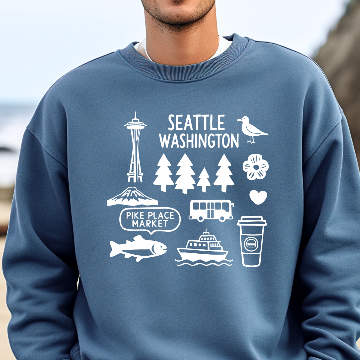 Person wearing a blue sweatshirt with white Seattle-themed graphics.