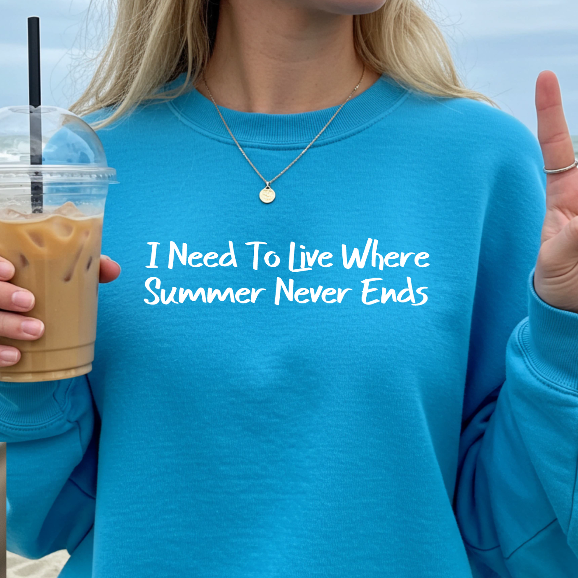 Gildan sweatshirt featuring blue text that reads “I Need To Live Where Summer Never Ends.” Cozy beach-inspired pullover for those who love the sun and ocean lifestyle. Made with a soft cotton-poly blend, ribbed cuffs, and double-needle stitching for durability. Perfect for coastal adventures, vacations, or casual summer-style outfits. Ideal gift for beach lovers and anyone who wishes for endless summer days.
