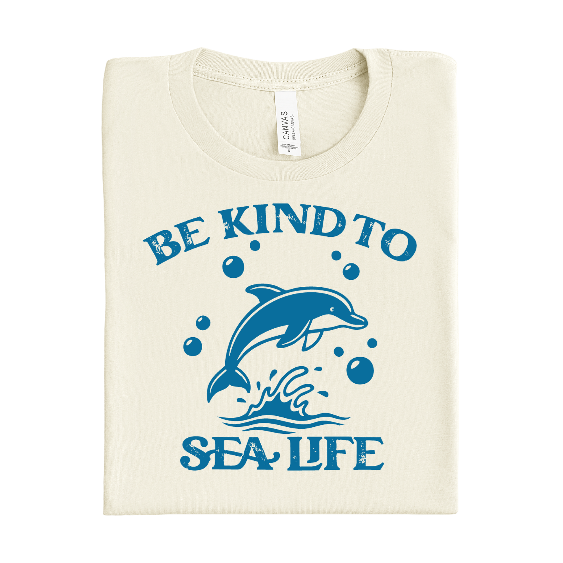 natural t-shirt with blue dolphin graphic and 'Be Kind to Sea Life' text on a white background