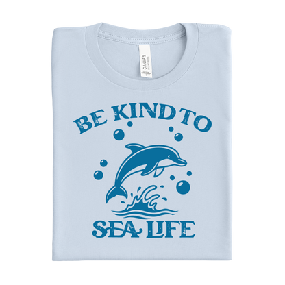 Light blue t-shirt with a dolphin graphic and 'Be Kind to Sea Life' text on a white background